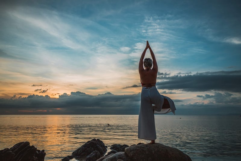 Woman Stretching at Sunset